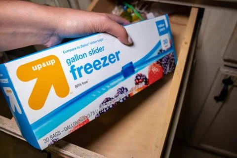 Hand picking up a box of zip lock bags Stock Photos