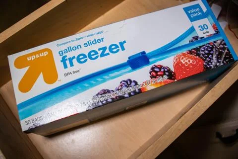 Hand picking up a box of zip lock bags Stock Photos