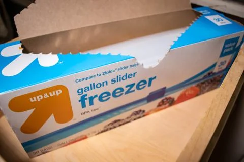 Hand picking up a box of zip lock bags Stock Photos