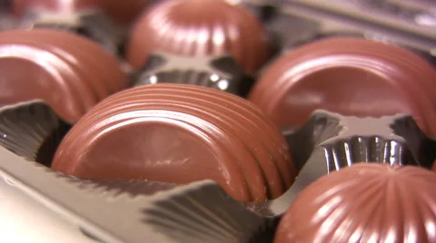 Hand picking candy from box of chocolates Stock Footage 55728563