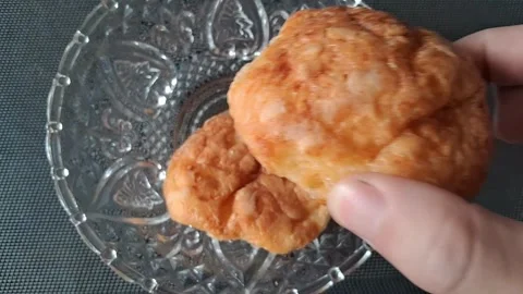Hand picking up a cheese bread. Close-up of a person grabbing baked snack from Stock Footage 341037609