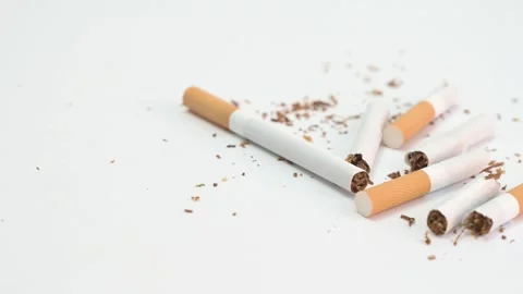 Hand picking up a cigarette from a pile of broken cigarettes Stock Footage 335191989