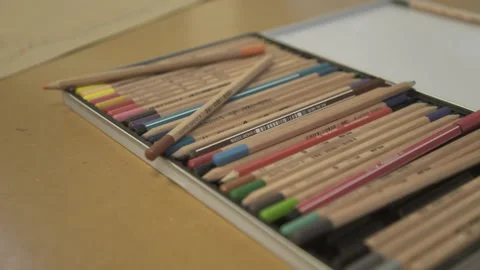 Hand picking up colored pencil from pencil case Stock Footage 138014716