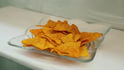 Hand picking a corn tortilla chip snack Stock Footage 341859169