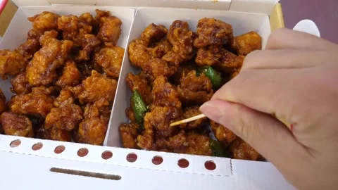 Hand Picking Crispy Korean Fried Chicken with Toothpick from Takeout Box Stock-Footage 343027519