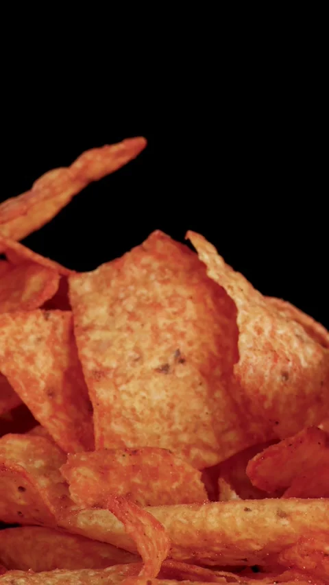 Hand Picking Crispy Nacho Chip from Pile on Black Background Stock Footage 320162941