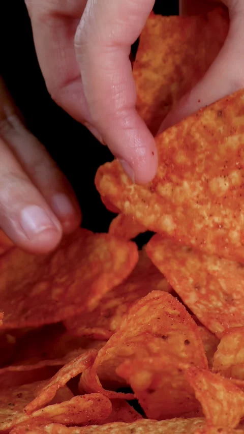 Hand Picking Crispy Nacho Chips Against Black Background Stock Footage 321853883
