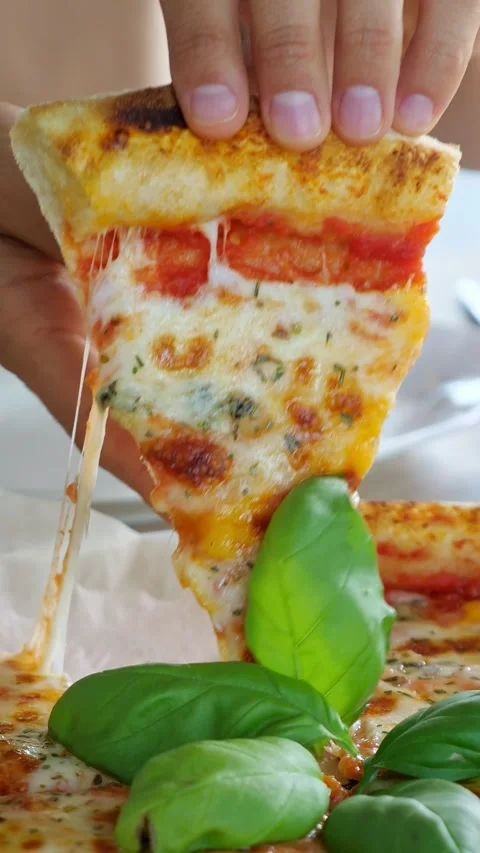 Hand picking up a delicious pizza slice with stretching cheese Stock Footage 341189177