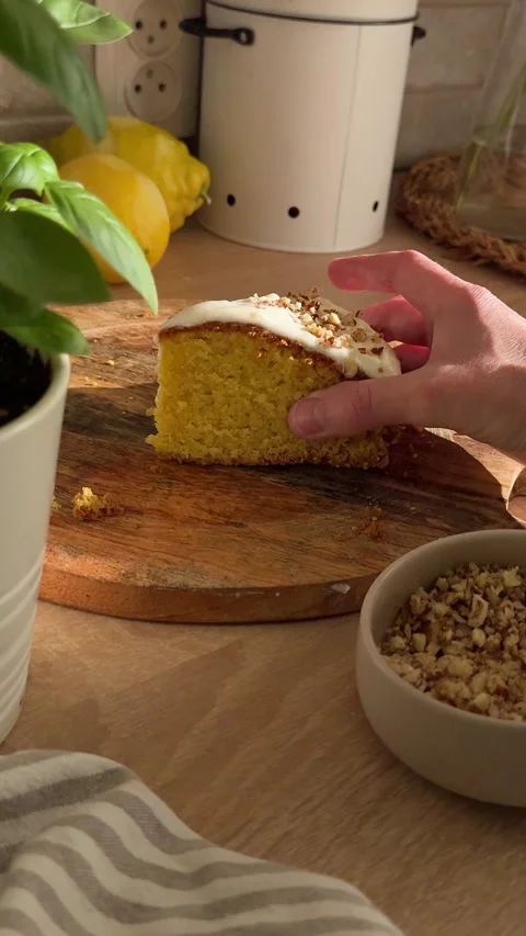 Hand picking up delicious slice of lemon cake Stock Footage 336995894