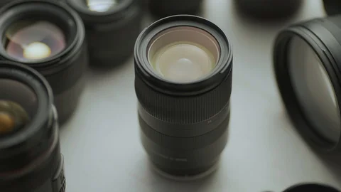 A hand picking down the lens of the camera between another lens. tools of trade  Video stock 128406104