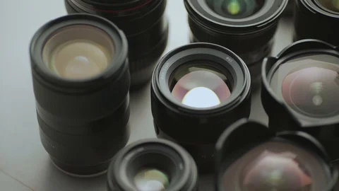 A hand picking down the lens of the camera between another lens. tools of trade  Video stock 128407230