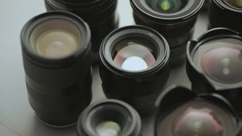 A hand picking down the lens of the camera between another lens. tools of trade  Video stock 128407300