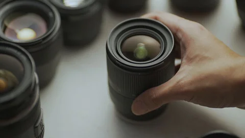 A hand picking down the lens of the camera between another lens Video stock 128407551