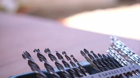 Hand picking drill bit from organized set, various sizes drill bits, Stock Footage 345870914