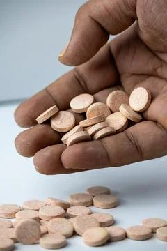 Hand Picking Effervescent Vitamin Tablets on White Background Stock Photos