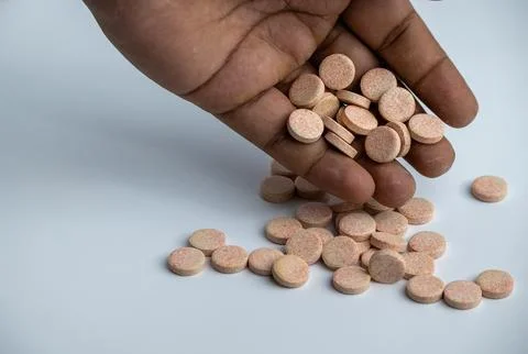 Hand Picking Effervescent Vitamin Tablets on White Background Stock Photos