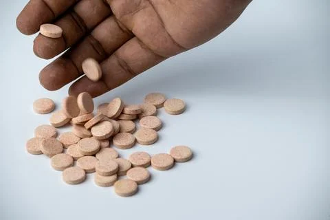 Hand Picking Effervescent Vitamin Tablets on White Background Stock Photos