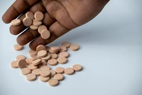 Hand Picking Effervescent Vitamin Tablets on White Background Stock Photos