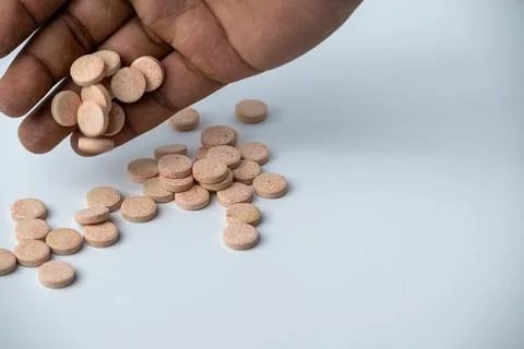 Hand Picking Effervescent Vitamin Tablets on White Background Stock Photos