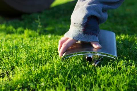 Hand picking up a flask Stock Photos