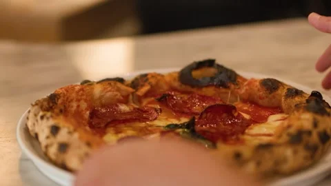 Hand Picking Up Fresh Neapolitan Pepperoni Pizza from Marble Table Stock Footage 337281181