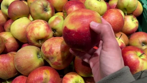 Hand picking fresh red apple from bin in store Stock Footage 336234148