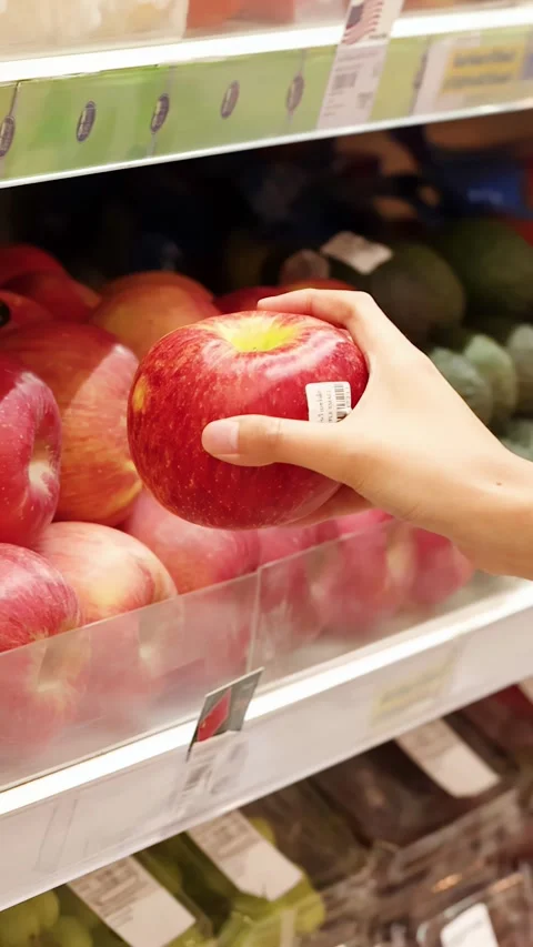 Hand Picking Fresh Red Apple from Supermarket Shelf Stock Footage 344624842