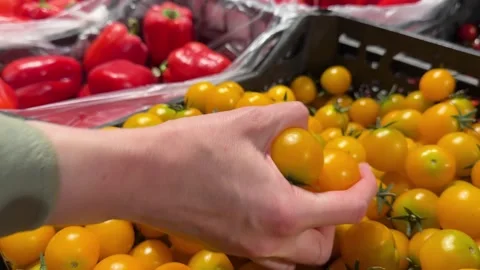 Hand Picking Fresh Yellow Cherry Tomatoes from Market Crate Stock Footage 345932085