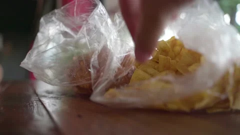 Hand picking fried crispy banana chip snack Video stock 137012140