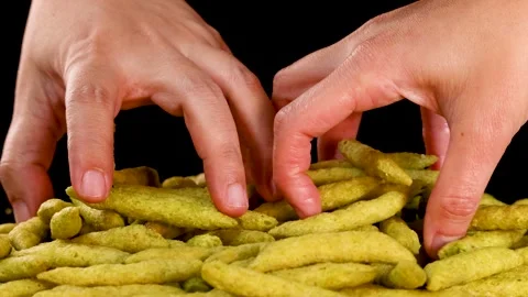 Hand Picking Up Green Pea Crispy Snack Sticks Stock Footage 319512651