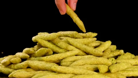 Hand Picking Green Pea Crispy Snack From Pile Stock Footage 320986825