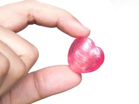 Hand picking heart  candy Stock Photos