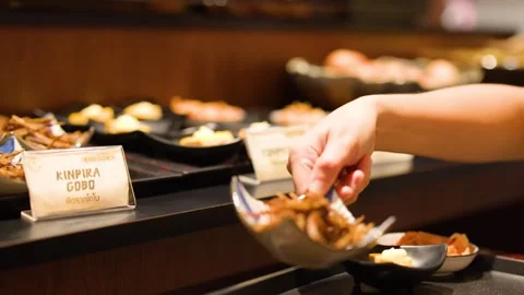 Hand Picking Up Kinpira Gobo Side Dish at Japanese Buffet Stock Footage 341395290