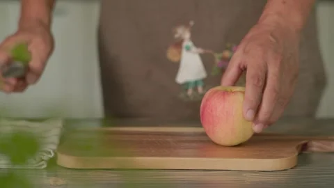 Hand Picking Up Kitchen Knife to Cut Apple Stock Footage 344778633
