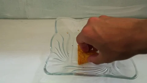 Hand picking up the last tortilla chip from a bowl Stock Footage 341859028