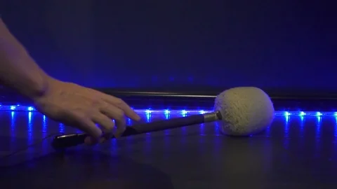 Hand picking a mallet for gong in a dark meditation room. Slow motion. Stock Footage 100292585