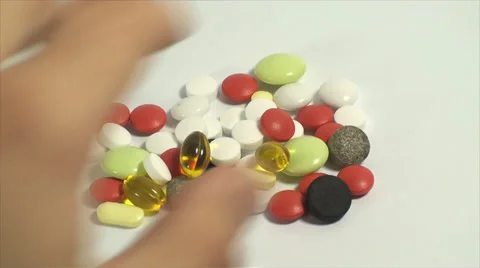 Hand Picking Up Pills On A White Background, Medical, Medicine, Cure, Treatment Stock-Footage 39351153