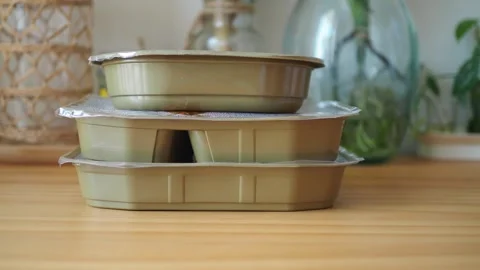 Hand Picking Up a Plastic Food Container from a Stack Stock Footage 346516207