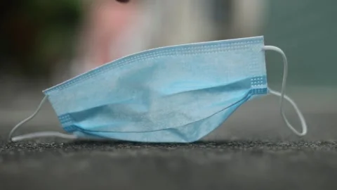 Hand picking up a protective mask on the floor Stock Footage 158586481