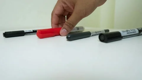 Hand Picking Red Marker from Black Markers Stock Footage 318578338