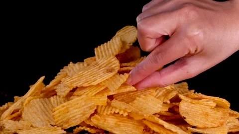 Hand Picking Up Ridged Potato Chips From Pile Stock Footage 317599515
