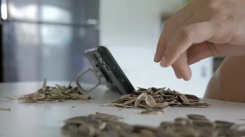 Hand picking roasted sunflower seed and eat. Stock Footage 153824982