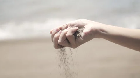Hand picking sand on the beach Stock Footage 159798717