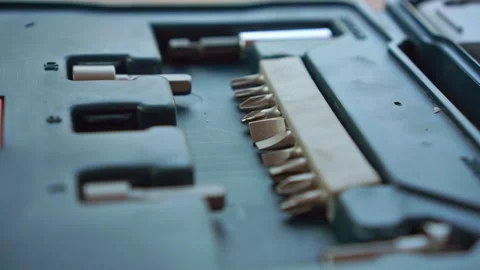Hand picking a screwdriver bit from a metal tool organizer, Vídeo Stock 347685570