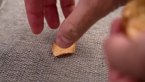 Hand picking up a slice of dried apple chip Video stock 250597772