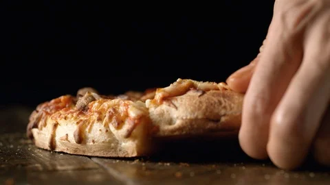 A hand picking up a slice of pizza out of a whole pizza. Slow Motion. Stock Footage 121495421