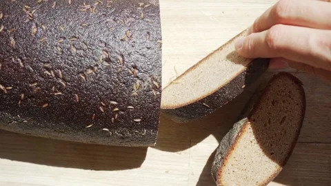 Hand picking a slice of rye bread Stock Footage 142441679