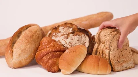 Hand Picking Sliced Multigrain Bread from Assorted Bakery Products Stock Footage 337519491