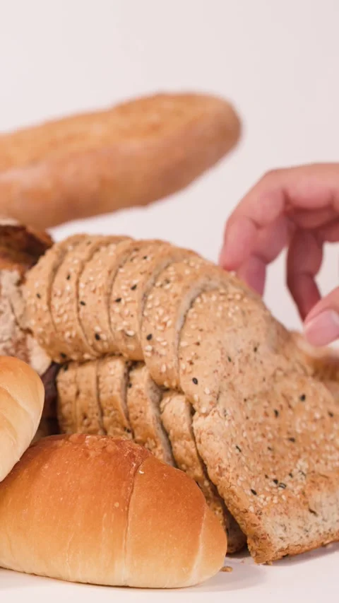 Hand Picking Sliced Multigrain Bread from Assorted Bakery Products Stock Footage 337519968