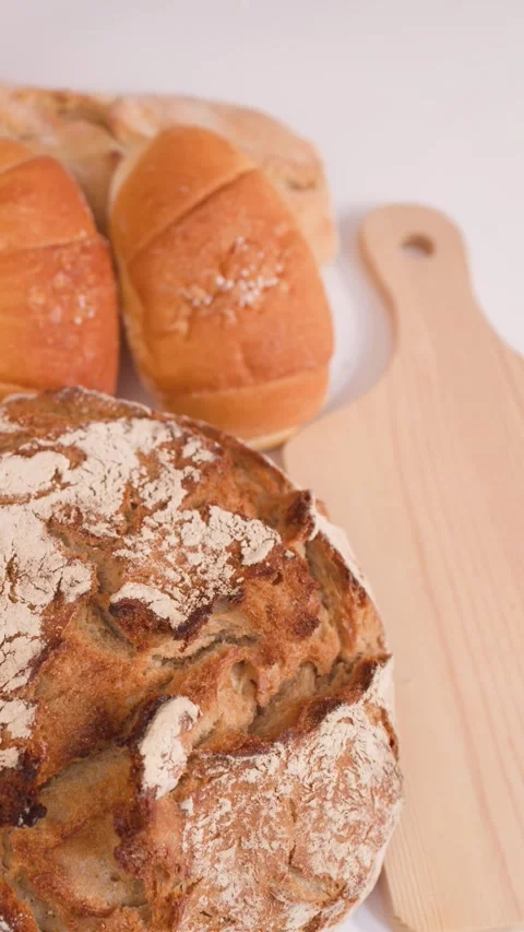 Hand Picking Up Sliced Seeded Bread From Assorted Bakery Display Stock Footage 337767899
